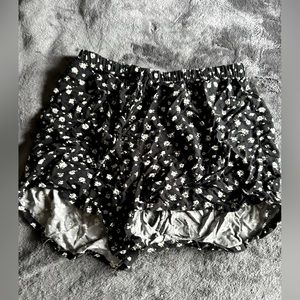 Rue21 loose black shorts with daisies. Never worn